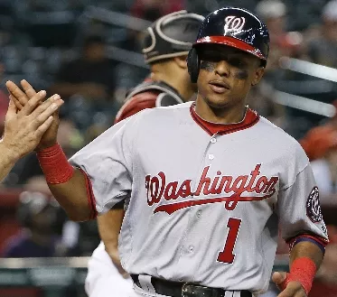 Washington Nationals' Wilmer Difo (1) celebrates his run scored against the Arizona Diamondbacks with Danny Espinosa, left, during the ninth inning of a baseball game Wednesday, Aug. 3, 2016, in Phoenix. The Nationals defeated the Diamondbacks 8-3. (AP Photo/Ross D. Franklin)