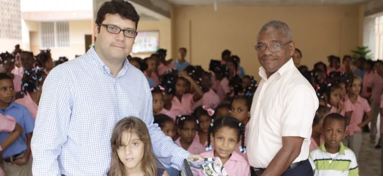 Edward Sanz, Saida Nazaret Sanz y Jonny Sosa entregan  útiles a los niños.