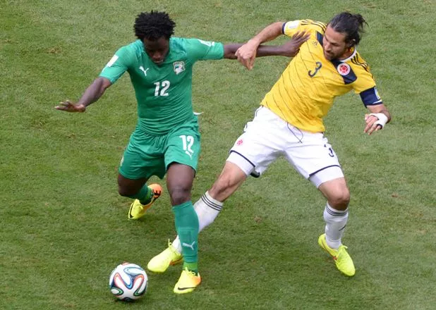 Ivory Coast’s forward Wilfried Bony (L) challenges Colombia’s defender Mario Alberto Yepes during the Group C football match between Colombia and Ivory Coast at the Mane Garrincha National Stadium in Brasilia during the 2014 FIFA World Cup on June 19, 2014.  AFP PHOTO / EVARISTO SA
