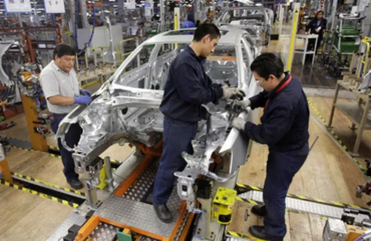 Employees work on the assembly line on the Jetta Bicentennial at the Volkswagen automobile manufacturing factory in Puebla