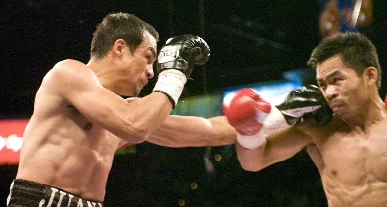 BOXING: PACQUIAO DETHONES MARQUEZ TO CLAIM SUPER FEATHER TITLE