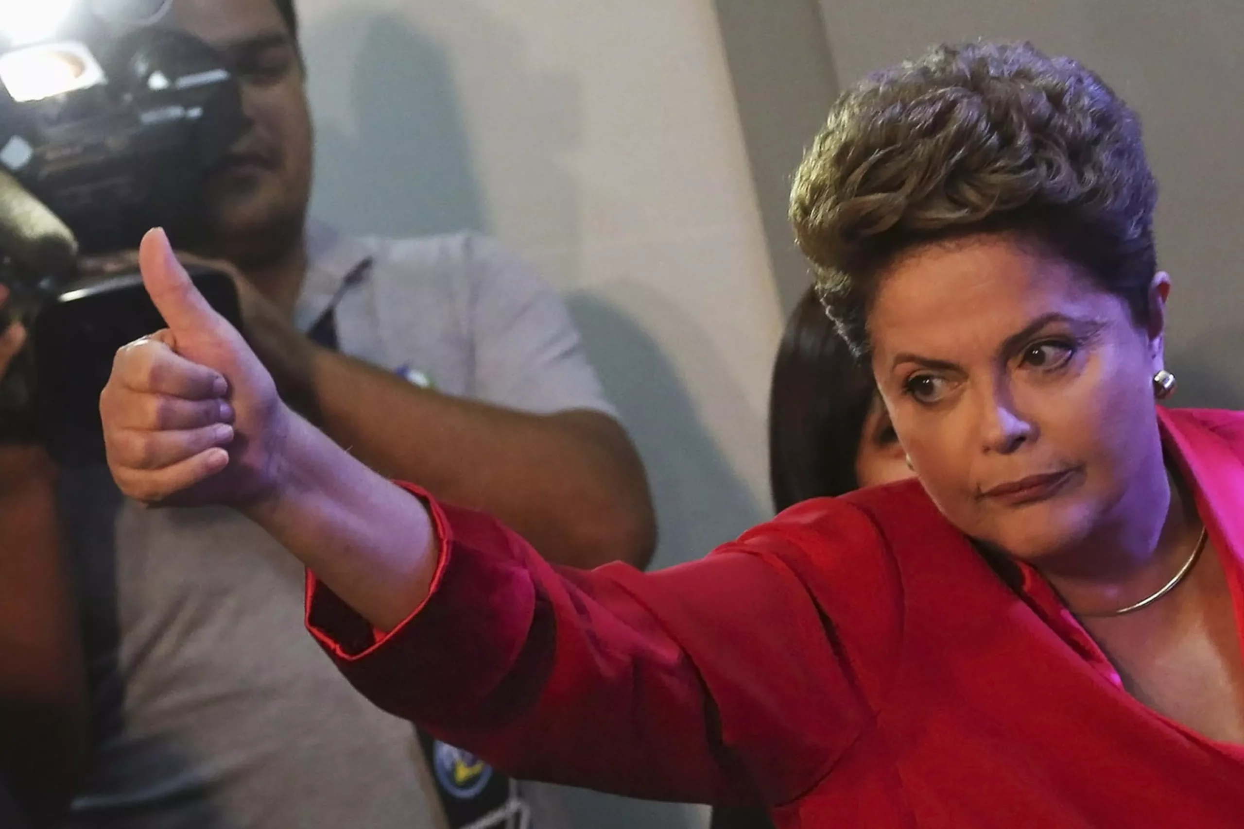 Brazil’s President and Workers' Party (PT) presidential candidate Dilma Rousseff gives a thumbs up to journalists as she arrives for a TV debate, in Sao Paulo