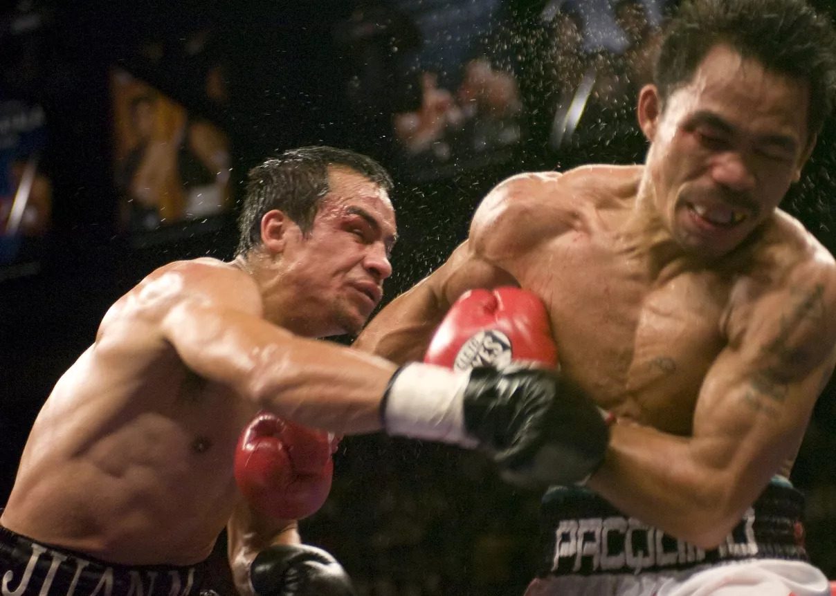 BOXING: PACQUIAO DETHONES MARQUEZ TO CLAIM SUPER FEATHER TITLE