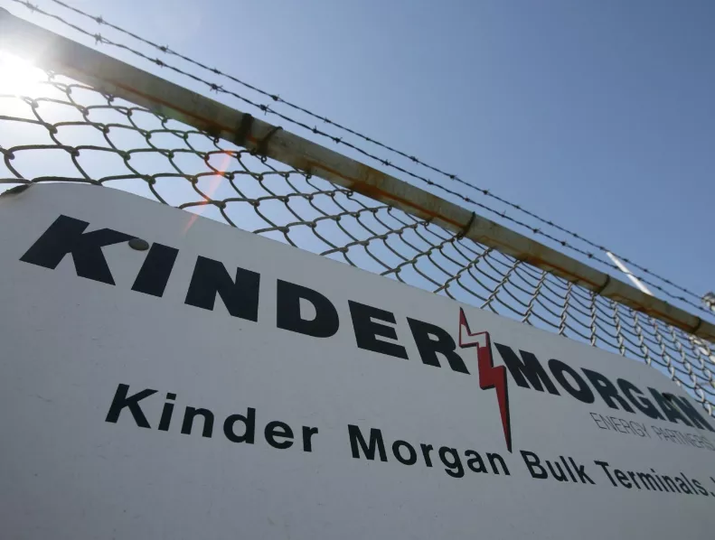 A sign hangs from a fence at a Kinder Morgan facility at the