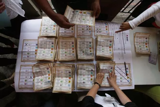 TOPSHOTSOfficials start counting votes at a polling station in Uruapan, Michoacan State, Mexico, on June 7,2015. Mexicans headed to the polls Sunday amid protests in the troubled southern state of Guerrero. The government of President Enrique Pena Nieto deployed troops and police this weekend to patrol the streets, skies and seas of Mexico to ensure people can cast their ballots. AFP PHOTO/HECTOR GUERRERO
