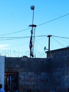 Una bandera dominicana, rota, colgada en una antena en la frontera con Haití.