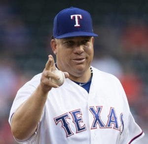 Texas Rangers starting pitcher Bartolo Colon acknowledges the Oakland Athletics bench before the first inning of a baseball game, Wednesday, June 6, 2018, in Arlington, Texas. (AP Photo/Jim Cowsert)