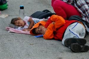 Niños que van en la caravana de migrantes duermen a la intemperie durante un receso, antes de proseguir su éxodo a Estados Unidos. (AP Photo/Marco Ugarte)