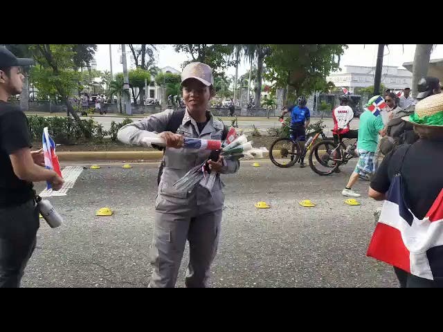 Militares y policías entregan flores y banderas a los manifestantes que llegan a Plaza de la Bandera