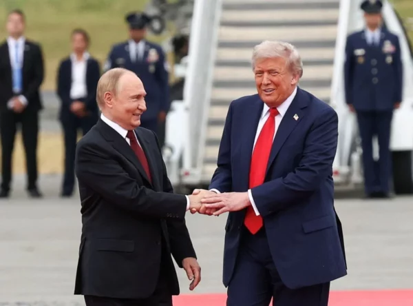 En foto de archivo, los presidentes Donald Trump y Vladimir Putin se saludan afablemente.