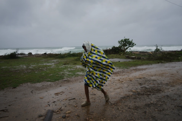 Un hombre camina bajo la lluvia antes de la llegada del huracán Melissa, en Canizo, una localidad en Santiago de Cuba, el 28 de octubre de 2025. (AP Foto/Ramón Espinosa)