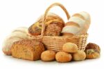 11844544 – composition with bread and rolls in wicker basket isolated on white