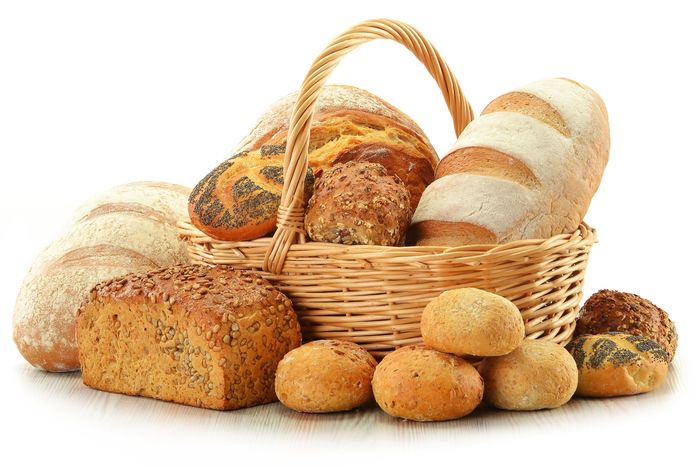 11844544 – composition with bread and rolls in wicker basket isolated on white