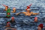 Swimmers participate in a Christmas Day race at the Serpentine in Hyde Park