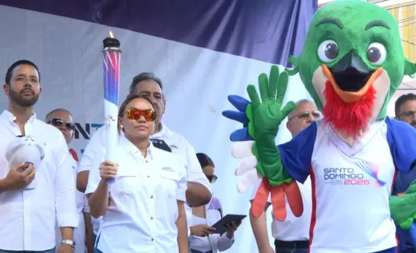 La gobernadora de Moca, Patricia Rivera, sostiene la antorcha de los Juegos Santo Domingo.