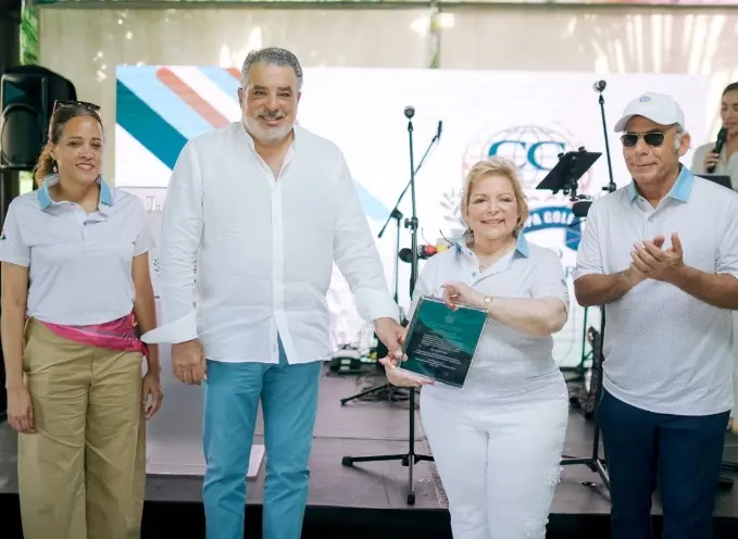 Rayza Rodríguez entrega reconocimiento a Enrique de Marchena en compañía de Margarita de los Santos y Emilio Hasbún.